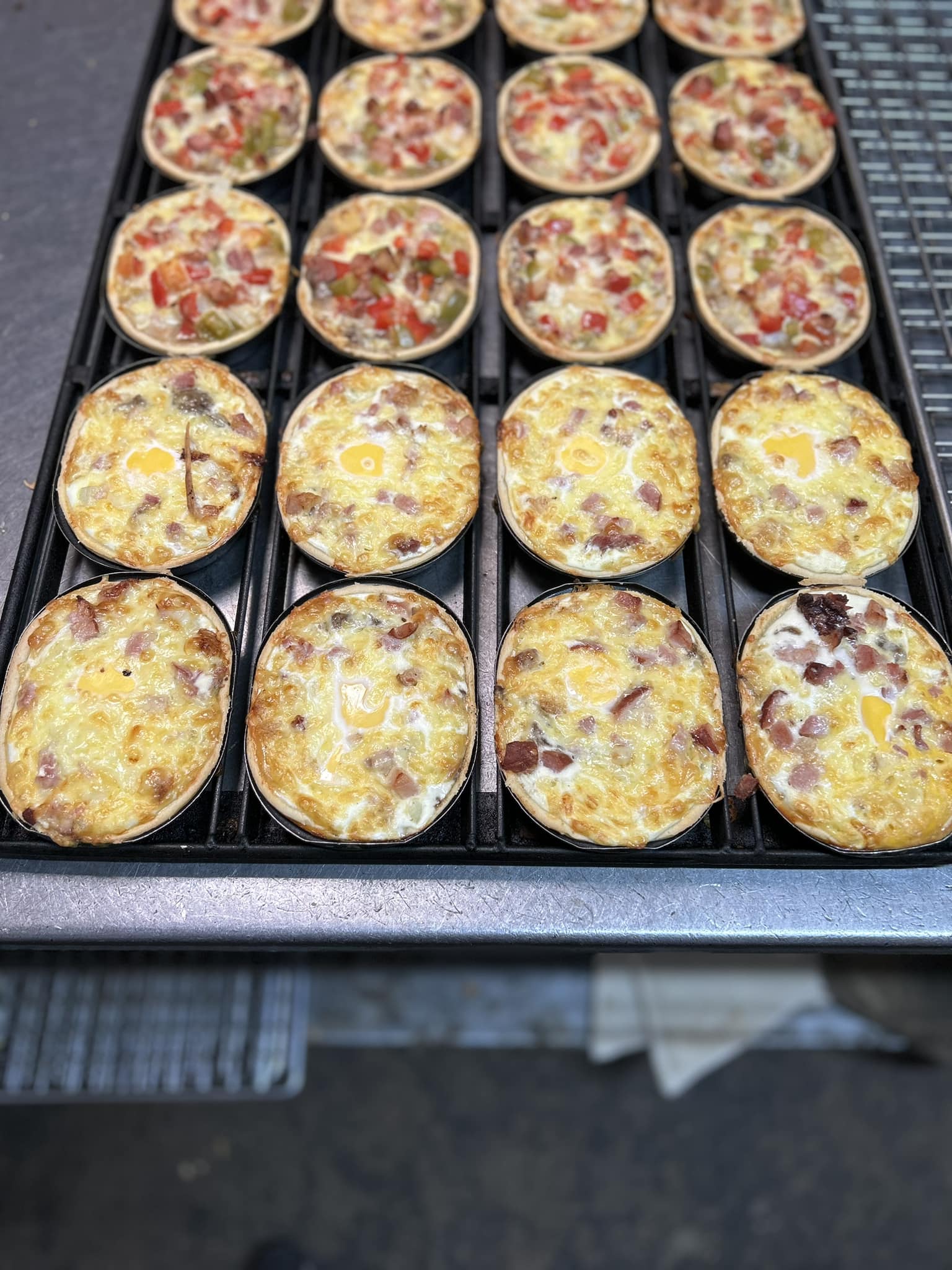 Freshly baked bacon and egg quiches on a cooling rack