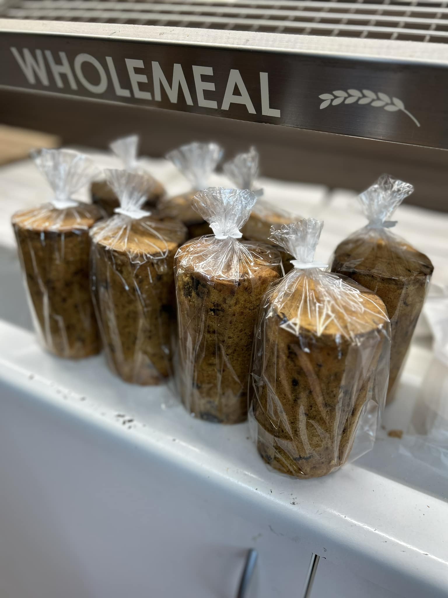 Wrapped wholemeal loaves under the wholemeal shelf label